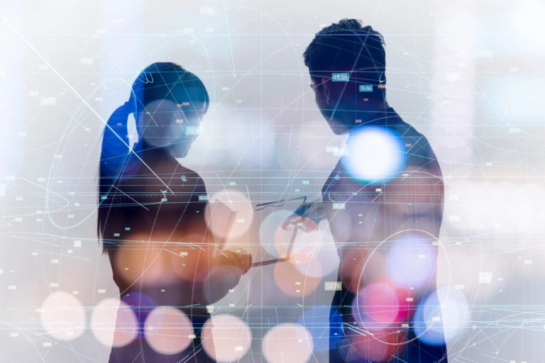 Two professionals reviewing digital data